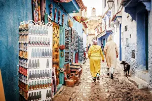 Shopping Prints: Local people walking in the street markets in the old medina of Chefchaouen, Morocco