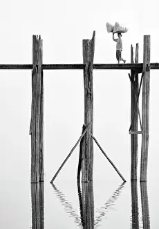 Mandalay Prints: Local woman carrying goods on her head across U Bein Bridge