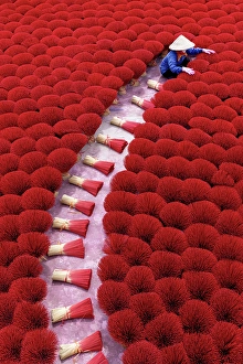 Hanoi Prints: Local woman laying out colourful Incense sticks to dry