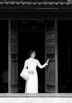 Hanoi Prints: Local woman wearing tradtional Ao Dai dress and holding conical hat at The Temple of Literature