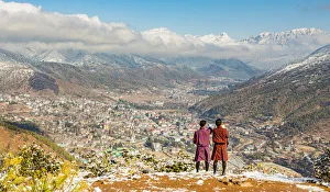 Two locals looking at city of Thimphu, Bhutan