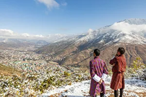 Two locals looking at city of Thimphu, Bhutan
