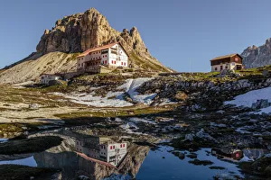 Lavaredo Prints: Locatelli refuge reflected in a puddle, Natural Park Three Peaks, Sesto Pusteria