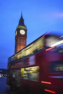 Images Dated 22nd July 2015: London, UK, Double Decker red bus passing in front of the Big Ben illuminated at dusk