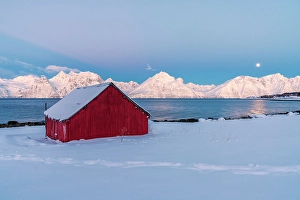 Moon Prints: Lone rorbu on a beach covered with snow