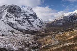 Looking down the pass of Glencoe with snow over the Three Sisters of Glencoe, Highland