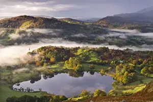 Lake District Prints: Loughrigg Tarn surrounded by misty autumnal countryside, Lake District, Cumbria, England