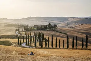 A loving couple found the perfect pic-nic spot: the fields in front of the Agriturismo Baccoleno, in the heart of the Crete Senesi, with all the rolling hills around. Tuscany, Italy