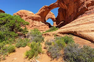 Low angle view of popular Double Arch on sunny day, Arches National Park, Utah, USA
