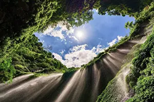 Environment Prints: Low angle view of powerful stream of Madakaripura waterfall falling from cliff in the tropical rainforest