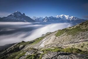 Low clouds and mist frame the snowy peaks of Mont Blanc and Aiguille Verte Chamonix