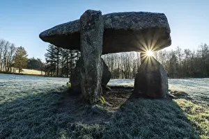 Neolithic Prints: Low winter sun rising through the Neolithic dolmen Spinsters Rock near Drewsteignton in