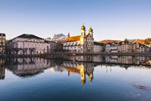 Lucerne, Switzerland. Jesuit church and Reuss rivers waterfront at sunrise