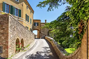 Clear Prints: Lucignano D'Asso, Tuscany, Italy: Street scene with buildings and archway on a sunny day
