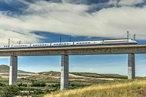 Railway Gallery: The Madrid-Barcelona AVE high-speed passenger train while is crossing a viaduct, Fuentes