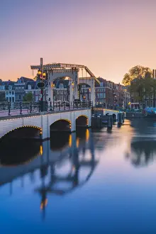 Urban Landscape Prints: Magere brug at dusk reflecting in the Amstel canal in Amsterdam, Holland / Netherlands