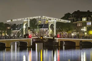 Images Dated 15th January 2015: Magere Brug over the river Amstel illuminated at night, Amsterdam, North Holland