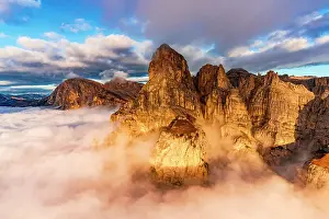 Parco Naturale Puez Odle Prints: Majestic peaks of Sassongher and Sass Da Ciampac (Puez Odle) emerging from fog at dawn in autumn