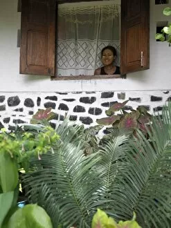 Images Dated 7th January 2006: A Malagasy woman admires her garden from the window