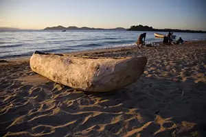 Malawi Prints: Malawi, Monkey Bay. An old dug-out canoe pulled up on to the beach of Lake Malawi
