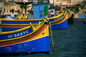 Malta, Europe; Traditional, brightly painted fishing boats known as luzzu
