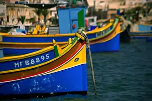 Malta, Europe; Traditional, brightly painted fishing boats known as luzzu