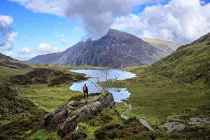 Snowdonia Prints: A man admires the view of Pen Yr Ole Wen and Llyn Idwal, Snowdonia, Wales, UK