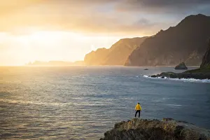 Man admiring the ocean from top of cliffs from Miradouro Do Guindaste viewpoint, Faial