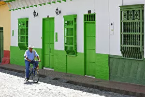 Images Dated 29th June 2012: Man on bike in streets of Santa Fe de Antioquia, Colombia, South America