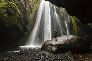 Cave Prints: Man into a cave in front of a waterfall