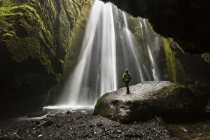 Gorge Collection: Man into a cave in front of a waterfall, Gljufrafoss, Skogar, Iceland, Northern Europe (MR)