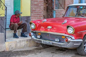 Ford Prints: Man and classic American vintage car in Trinidad, Trinidad and Sancti Spiritus Province