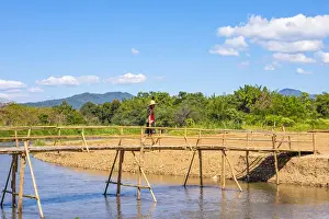 Color Image Prints: A man crossing a bridge over a river in Pai, Mae Hong Son province, Northern Thailand