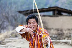 Bhutan Prints: A man doing archery in Paro District, Bhutan