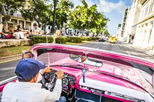 Images Dated 27th May 2020: A man driving a classic car in Centro Habana District, Havana, Cuba