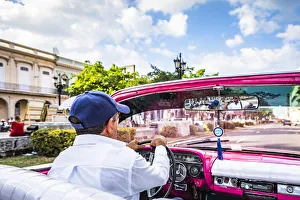 Habana Prints: A man driving a classic car in Centro Habana District, Havana, Cuba