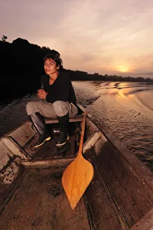 Man in dugout canoe on the Lago de Tarapoto, Amazon River, near Puerto Narino, Colombia
