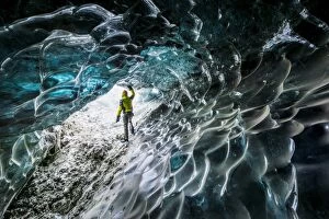 Man inside an ice caver under the Vatnajokull glacier, Vatnajokull national park