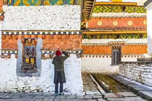 Prayer Gallery: A man in Jambey Lhakhang, Jakar, Bumthang District, Bhutan