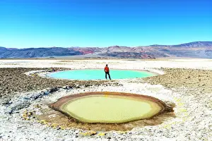 Salt Pond Prints: Man looking at colorful lagoons