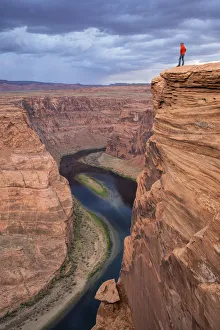Man looking over the Horseshoe Bend and the Colorado River, Glen Canyon National Rec Man looking over the Horseshoe Bend and the Colorado River, Glen Canyon National Rec