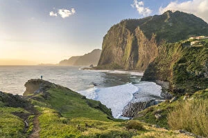 Trail Gallery: Man overlooking the village of Faial and its beach and cliffs