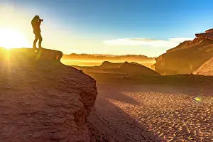 Exploration Prints: Man photographing the cracked dry soil in the Labyrinth Desert, Puna, Argentina. (MR)