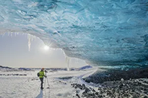 Observing Prints: Man photographs an ice cave of Breidamerkurjokull, Austurland, Iceland