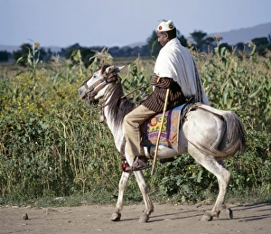 Images Dated 5th February 2009: A man rides to market on his gaily-caprisoned pony