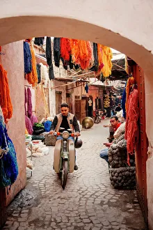 Textile Prints: Man on a scooter through the colorful streets of the medina of Marrakech