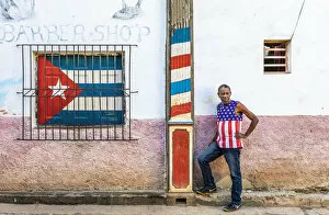 Images Dated 27th May 2020: A man standing outside a barber shop in La Habana Vieja (Old Town), Havana, Cuba