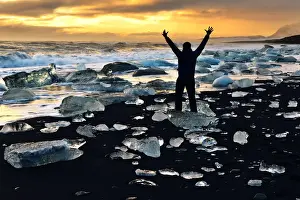 Norbert Eisele Hein Prints: Man stands amongst the icebergs, Glacial lake with icebergs Jokulsarlon, Iceland