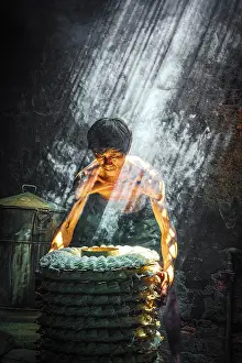 Cook Prints: Man steaming rice cakes in a traditional kitchen