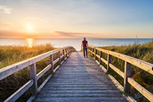 Images Dated 25th August 2017: Man walking on a footbridge to Weissenhaauser Strand, Ostholstein, Schleswig-Holstein